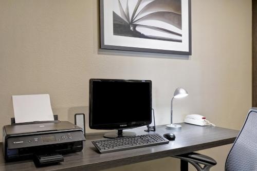 a desk with a computer and a printer on it at Candlewood Suites Indianapolis - South by IHG in Greenwood