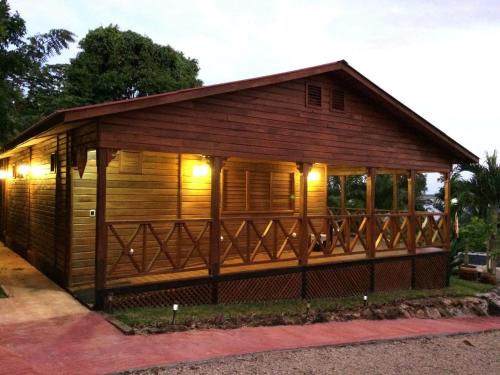 a large wooden cabin with lights on it at Coras Place Bacalar Lagoon front in Bacalar