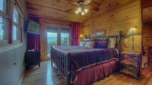 a bedroom with a bed in a log cabin at Heavens Whisper in Blue Ridge