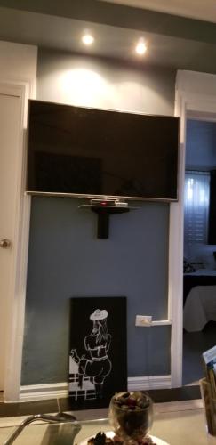 a flat screen tv hanging on a wall at Apartment Treasure at Sandcastles in Ocho Rios