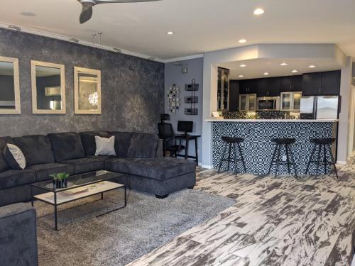 a living room with a couch and a bar at *NEW* Lux Scottsdale Home with Pool, Hot Tub, and Gym in Scottsdale