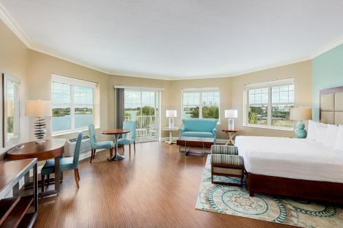 a bedroom with a bed and a table and chairs at The Waterfront Inn in The Villages