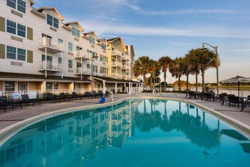 a swimming pool in front of a building at The Waterfront Inn in The Villages
