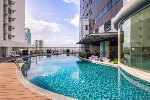 a swimming pool on the roof of a building at TROVE Johor Bahru in Johor Bahru