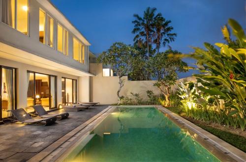 a swimming pool in the backyard of a house at Danoya Private Luxury Residences in Seminyak