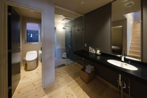 a bathroom with a sink and a toilet at Kamome Jyuku in Takamatsu