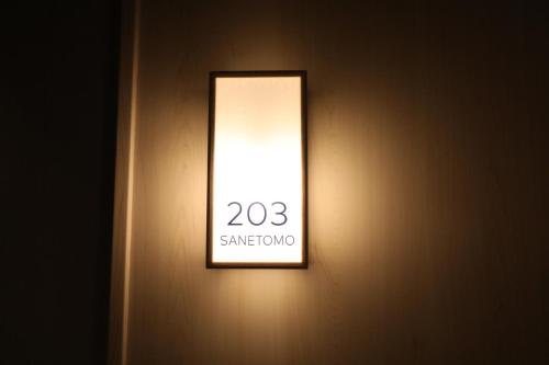 a lightswitch on a wall with a sign on it at GEN HOTEL KAMAKURA in Kamakura