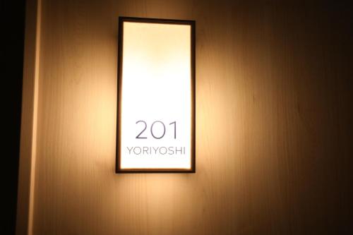 a mirror on a wall with a sign on it at GEN HOTEL KAMAKURA in Kamakura