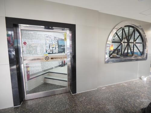a door with a window on the side of a building at 合悅都會商旅 Heyue HOTEL in Hsinchu City