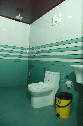 a bathroom with a toilet and a sink at Marari Baiju's Homestay in Mararikulam