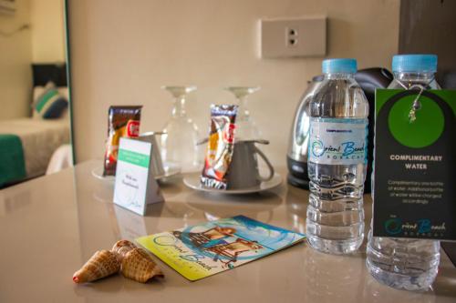 a table with a bottle of water and snacks on it at The Orient Beach Boracay in Boracay