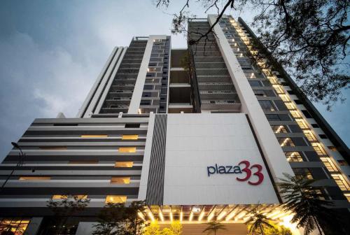a tall building with a pizza sign on it at NETFLIX-Pinnacle PJ, Fantastic City View, 1-6 Guests Designed Duplex Home by Flexihome-MY in Petaling Jaya