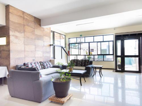 a living room with a couch and a table at HOTELES CATEDRAL Torreón in Torreón