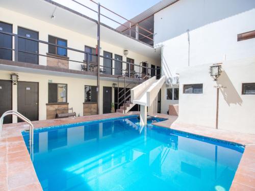 a swimming pool in the middle of a building at HOTELES CATEDRAL Torreón in Torreón