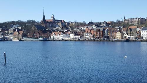 a large body of water with a city in the background at Loft 5 - Urlaub direkt an der Förde in Flensburg