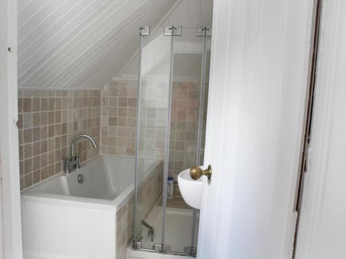 a bathroom with a bath tub and a sink at The Eaves in Sandgate