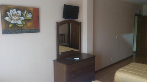 a bedroom with a dresser and a mirror at Las Mairas in Fuente Encalada