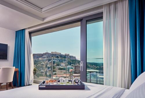 a hotel room with a view of a city at Electra Metropolis in Athens