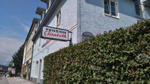 a sign for a restaurant on the side of a building at Pension Elisabeth - Rooms & Apartments in Salzburg