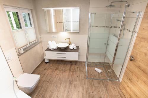 a bathroom with a shower and a sink at Ferienwohnungen "Zur Wally" in Garmisch-Partenkirchen