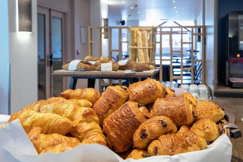 a pile of pastries on a table in a bakery at SOWELL HOTELS Mont Blanc et SPA in Saint-Gervais-les-Bains
