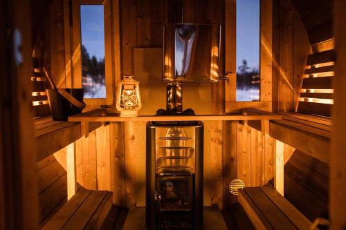 a small room with a window and a lantern at Aurora Village Ivalo in Ivalo