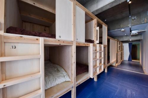 a group of bunk beds in a room at Guesthouse & Lounge FARO iwaki in Iwaki