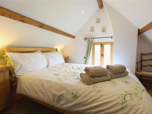 a bedroom with a bed with towels on it at The Shooting Folly in Cheswardine
