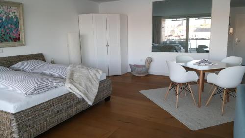 フレンスブルクにあるLoft 5 - Urlaub direkt an der Fördeのベッドとテーブルと椅子のある寝室