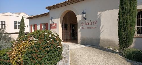 a building with a sign on the front of it at Charmant T2 climatisé avec belle vue , Golf de Pont-Royal in Mallemort