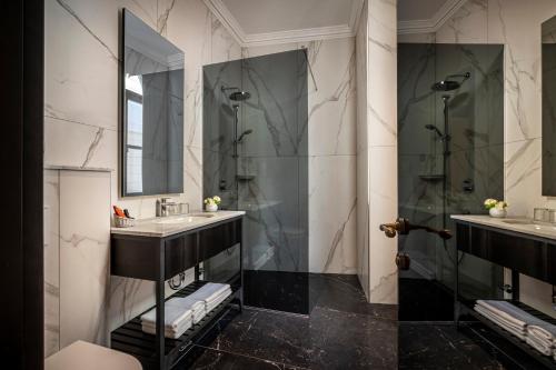 a bathroom with two sinks and a shower at Valamar Riviera Hotel & Residence in Poreč