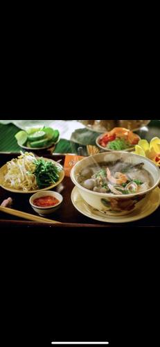 a table with several plates of food on it at Hoang Duc Hotel in Chau Doc