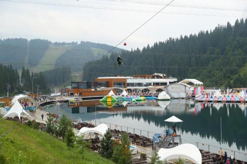 a person riding a bike over a body of water at Bukovel Hotel in Bukovel