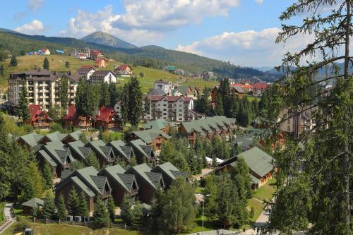 an aerial view of a town with houses and trees at Bukovel Hotel in Bukovel