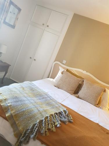 a bedroom with a bed with a blanket on it at The Covenanter Hotel in Falkland