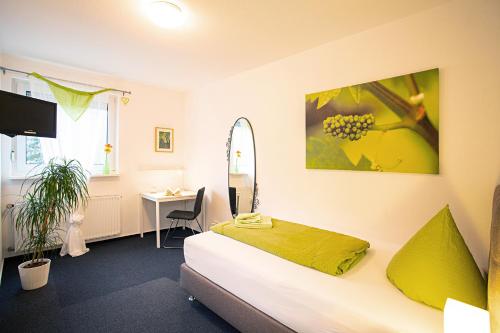 a bedroom with a bed and a desk in a room at Hotel Emmerich in Winningen