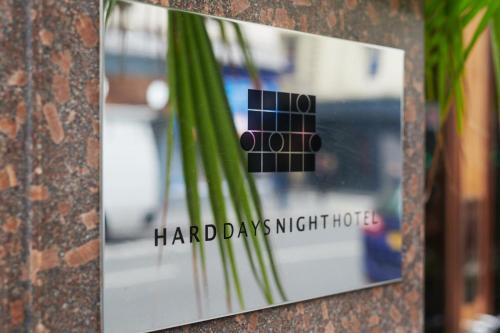 a picture of a sign on a wall with a plant at Hard Days Night Hotel in Liverpool