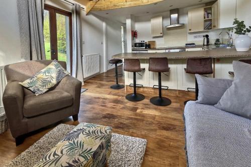 a living room with a couch and a kitchen at Lovely Somerset Getaway in Taunton