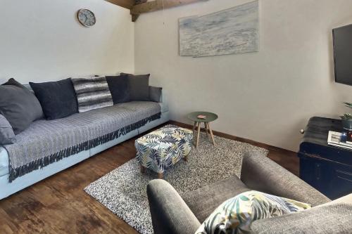 a living room with a couch and a table at Lovely Somerset Getaway in Taunton