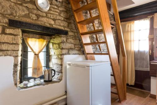 a white refrigerator in a room with a window at The Folly in Tetbury