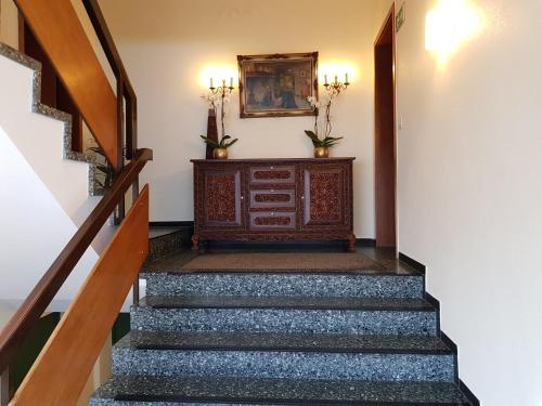 a hallway with stairs with a picture on the wall at Hotel Garni Elisabeth in Göppingen
