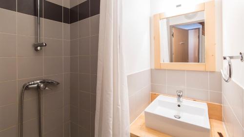 a bathroom with a sink and a shower at Vacancéole - Les Jardins de Balnéa in Loudenvielle