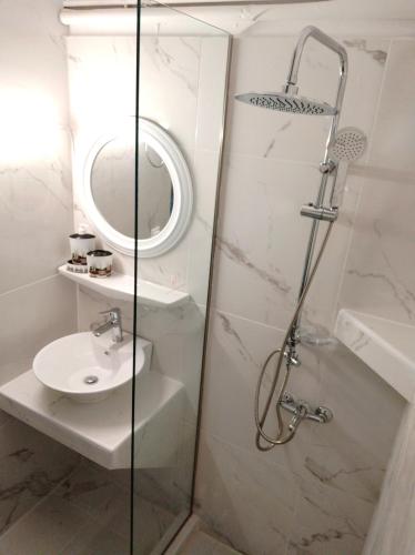 a bathroom with a shower and a sink at Art Studios Benitses in Benitses