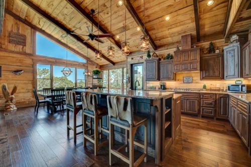 a kitchen with a large center island with bar stools at Serenity Cove in Blue Ridge