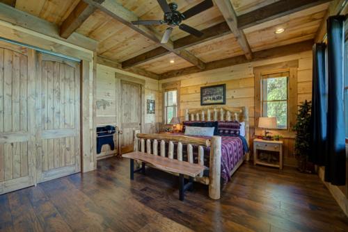 a bedroom with a bed and a wooden ceiling at Serenity Cove in Blue Ridge