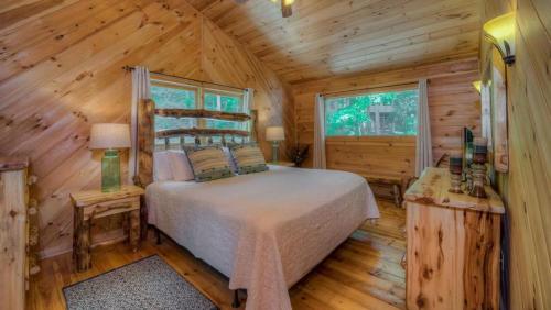 a bedroom with a bed in a log cabin at Southern Comfort in Morganton
