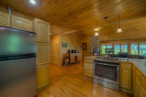 a large kitchen with wooden floors and a wooden ceiling at Skyline Lodge in Blue Ridge