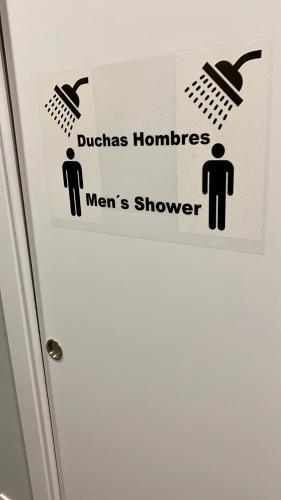 a sign on the door of a bathroom stall at Madrid Downtown Hostel in Madrid
