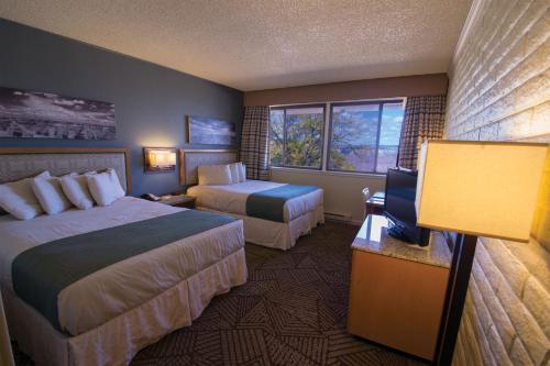 a hotel room with two beds and a television at Kachina Lodge - Inside the Park in Grand Canyon Village