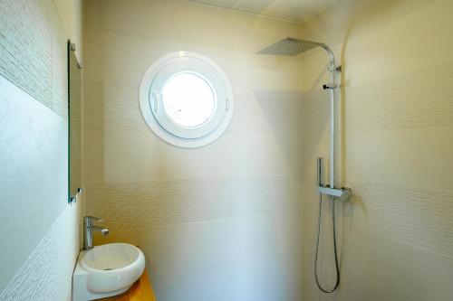 baño con aseo y ventana en Studio climatisé île naturiste du Levant en Hyères